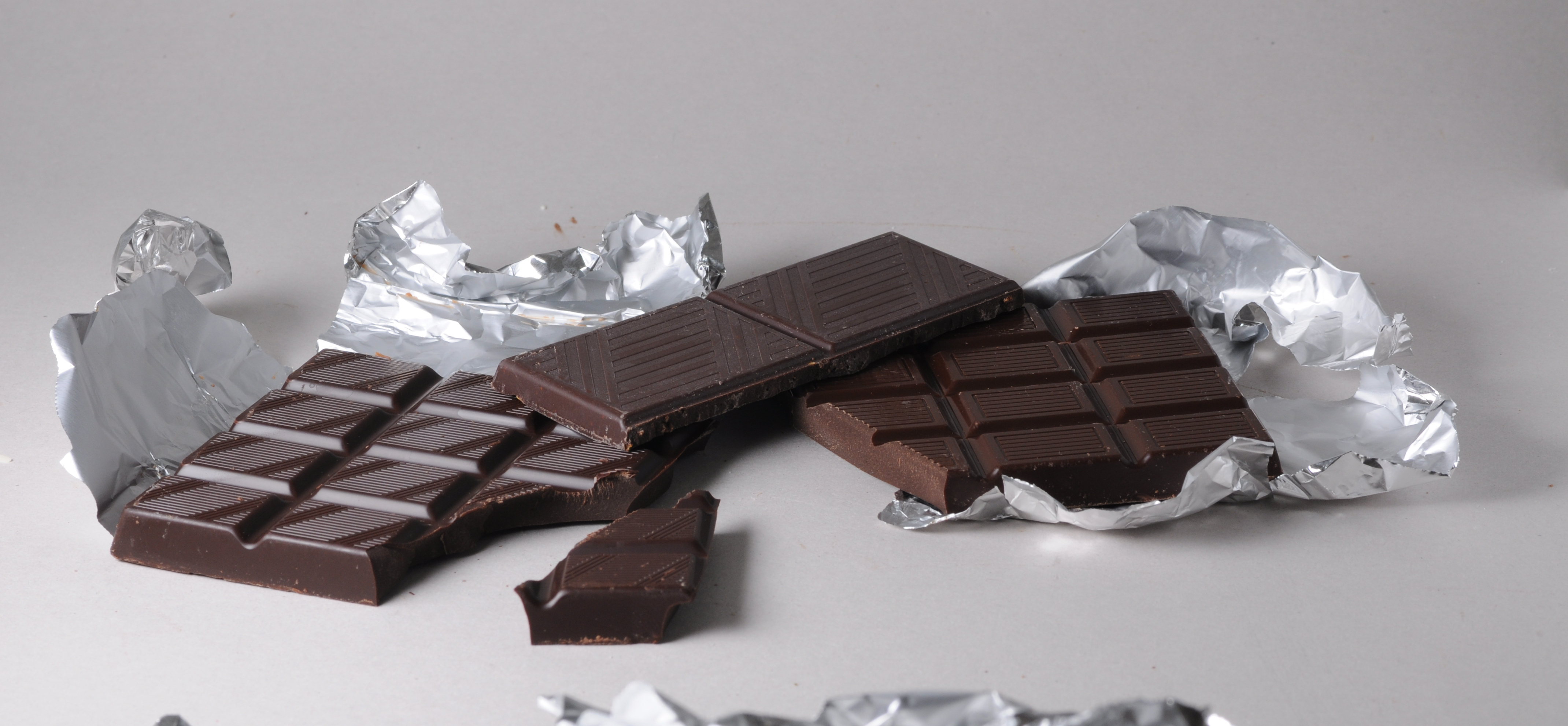 Bars of black Swiss Chocolate. From left to right: About 75% cacao; With chili; Normal black chocolate.