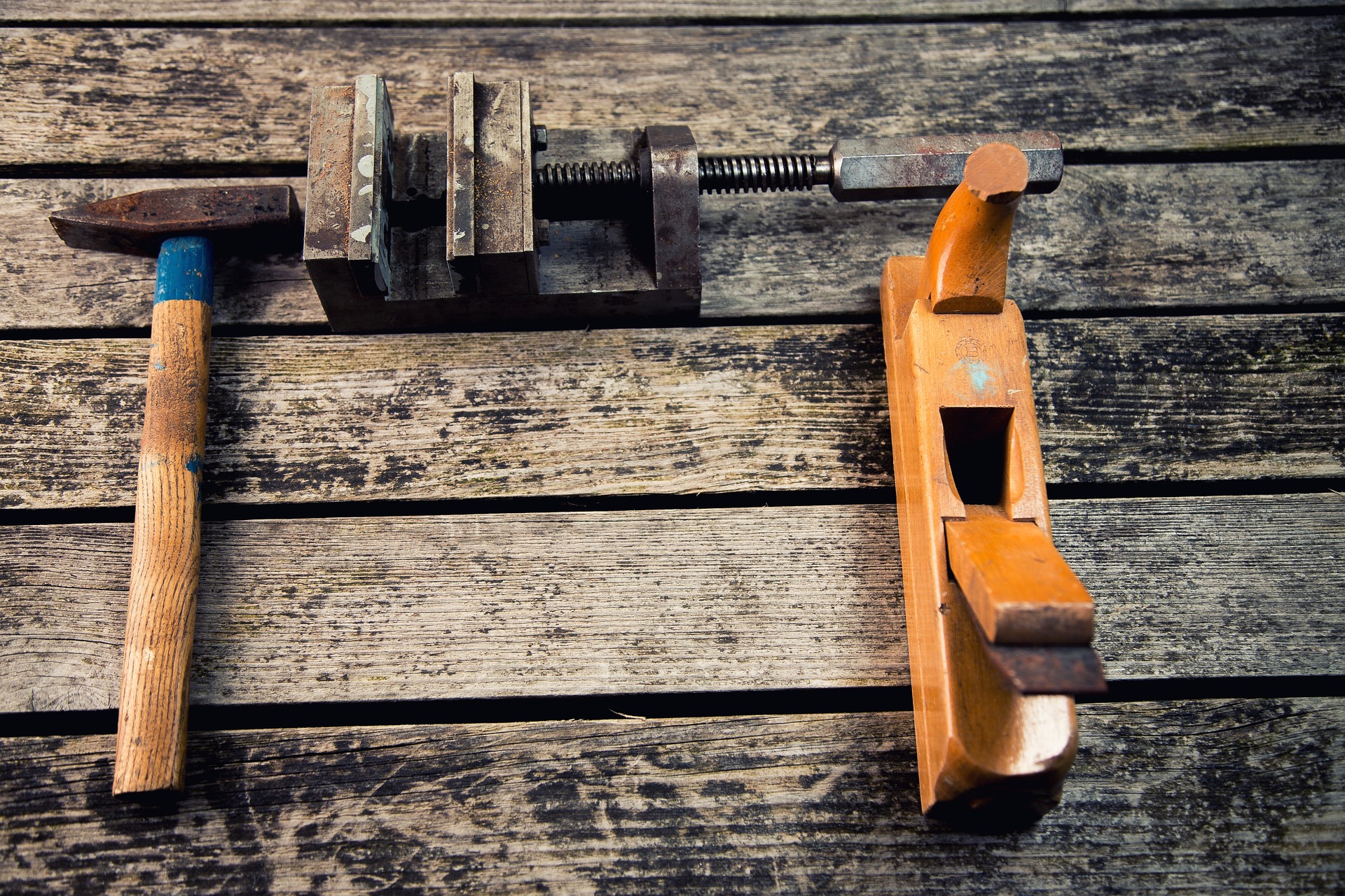 Tools for working with wood placed on a wooden surface.