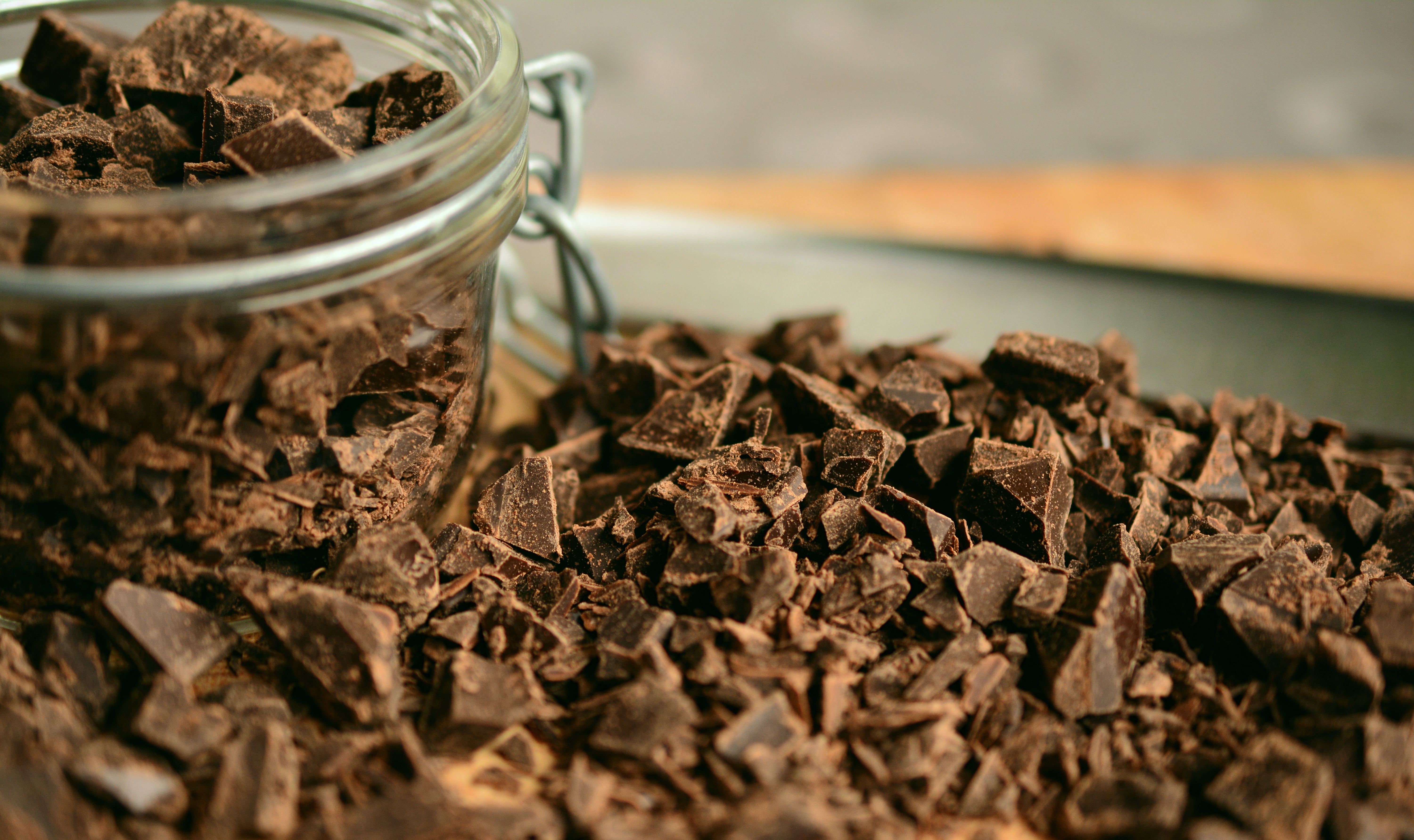 congerdesign, Pixabay License A mason jar filled, and surrounded, with chopped chocolate.