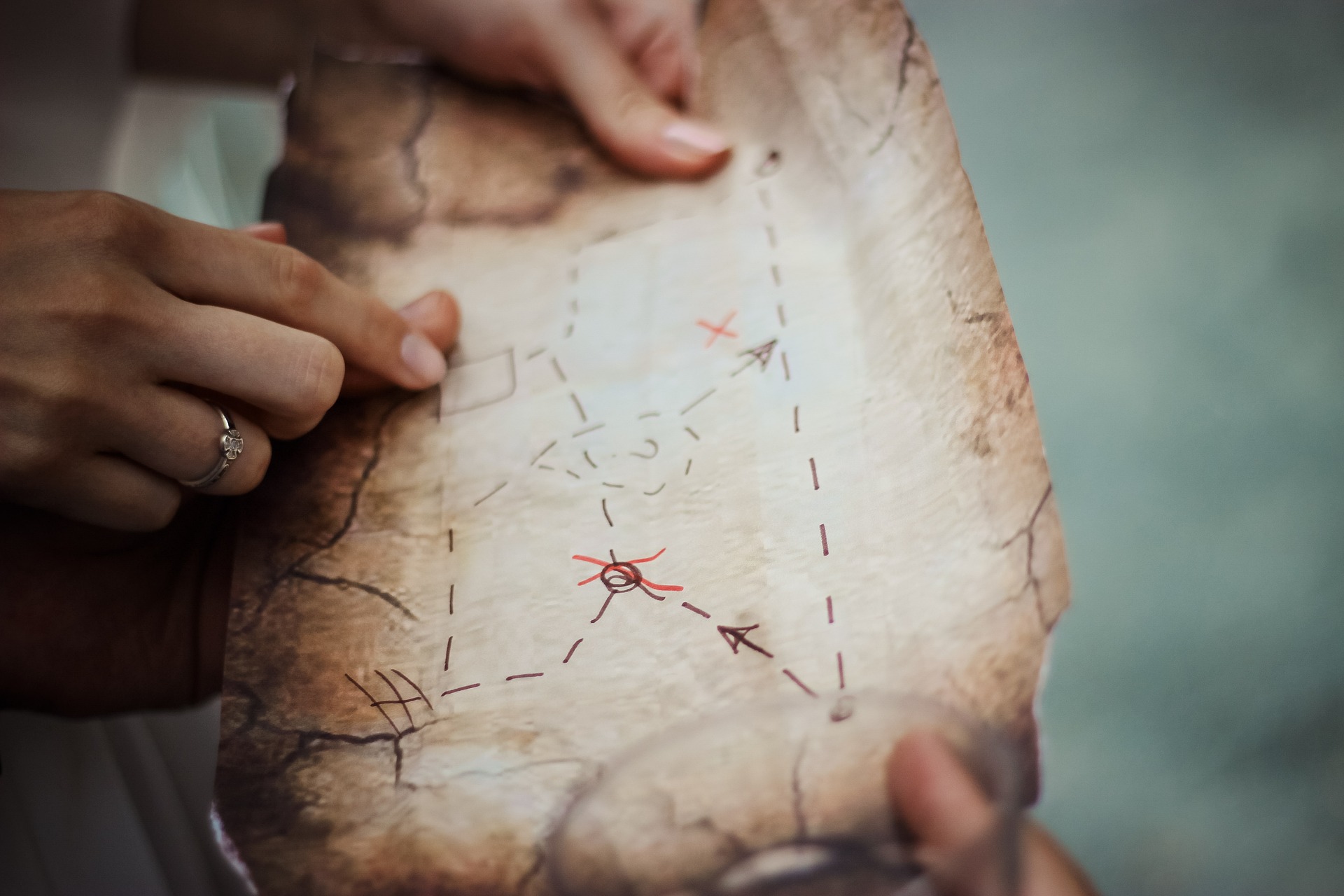 Image by Pexels from Pixabay Hands holding an old map