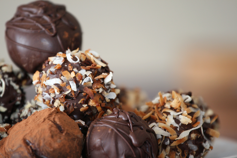 Truffles with nuts and chocolate dusting in detail.